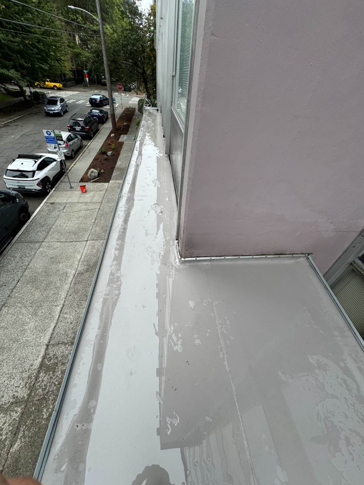 Same flat roof surface fully cleaned and uniform in color after professional cleaning